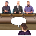Woman speaking to panel of 3 people at the DRC