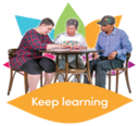 group of people at table looking intently at book and talking. Text reads 'keep learning'